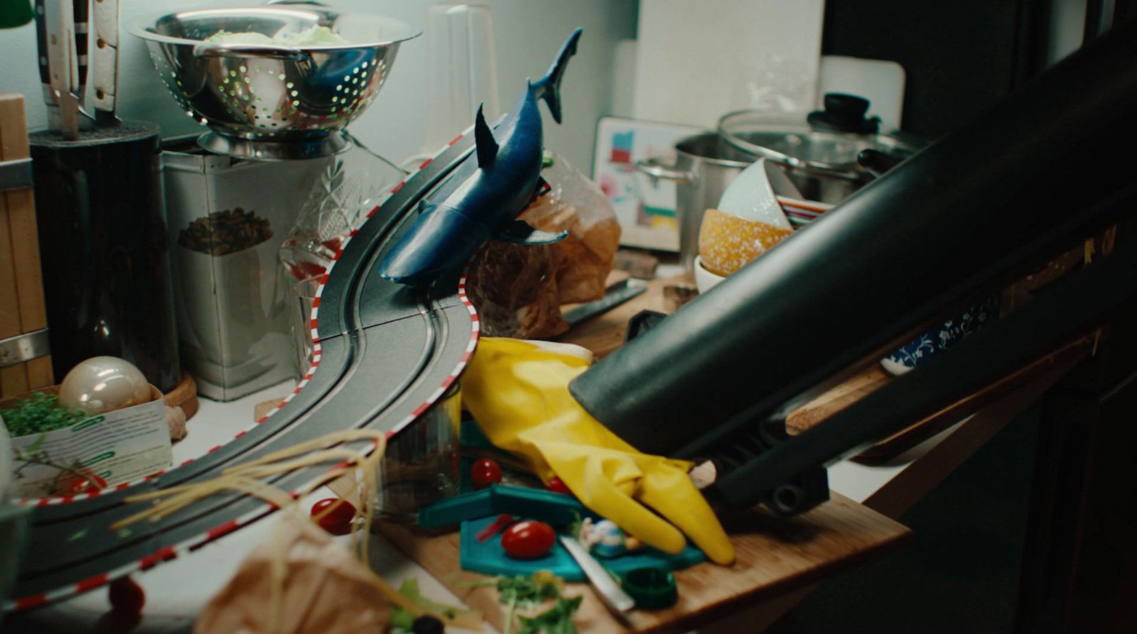 a kitchen counter with a bunch of clutter on it