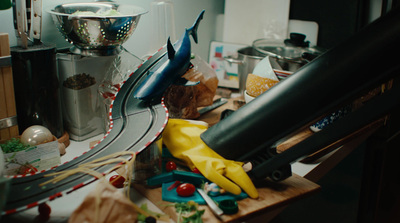 a kitchen counter with a bunch of clutter on it