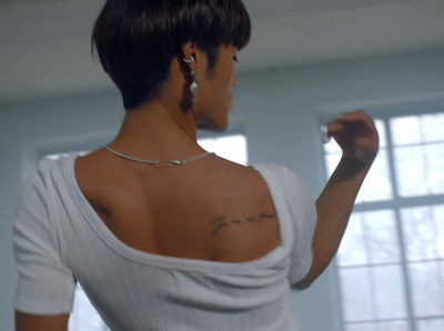 a woman with a tattoo on her upper back