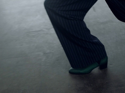 a person wearing a suit and green shoes