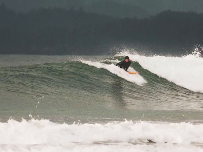 a man riding a wave on top of a surfboard