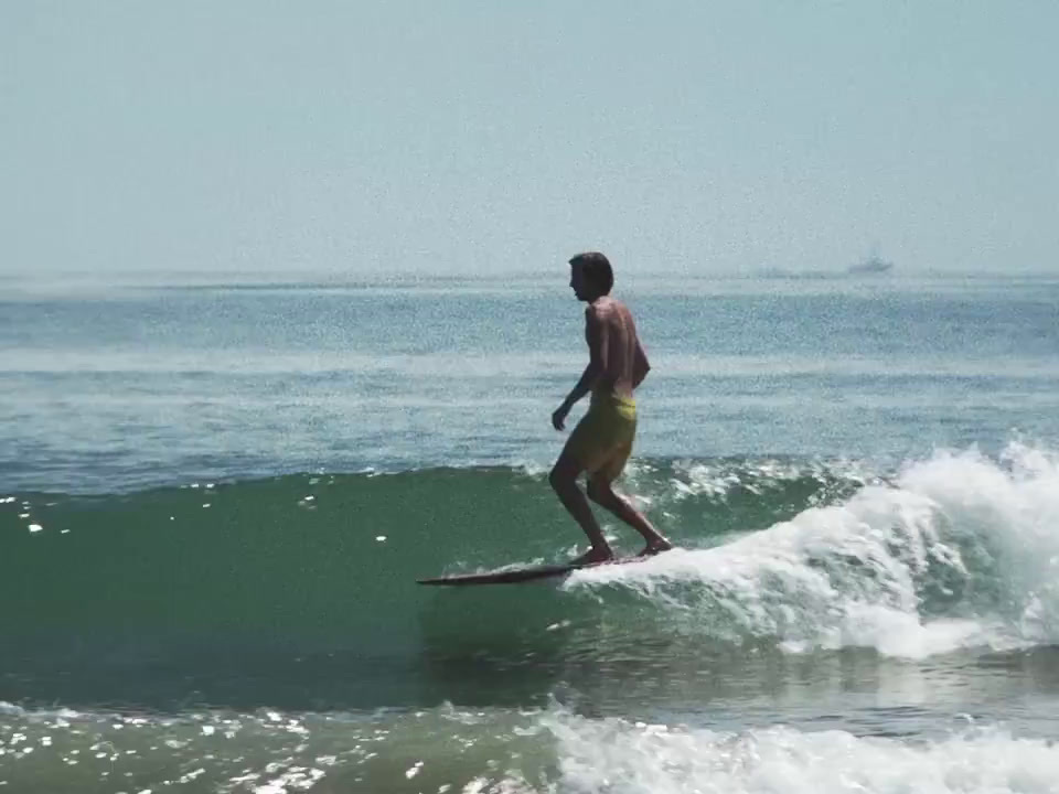 a man riding a wave on top of a surfboard