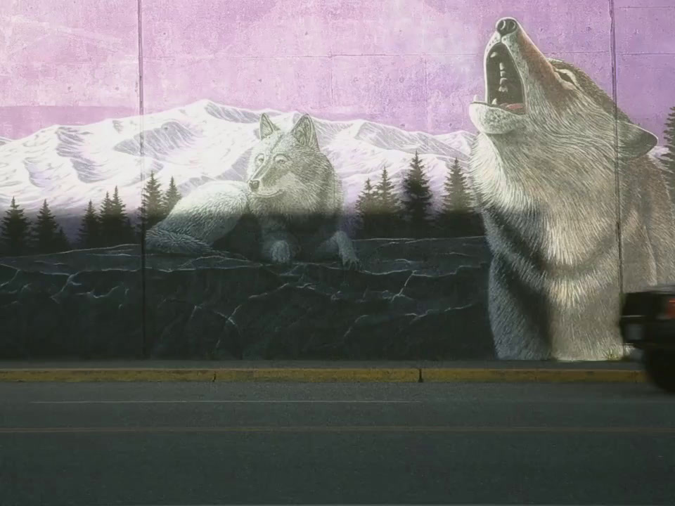 a mural of two bears on the side of a building