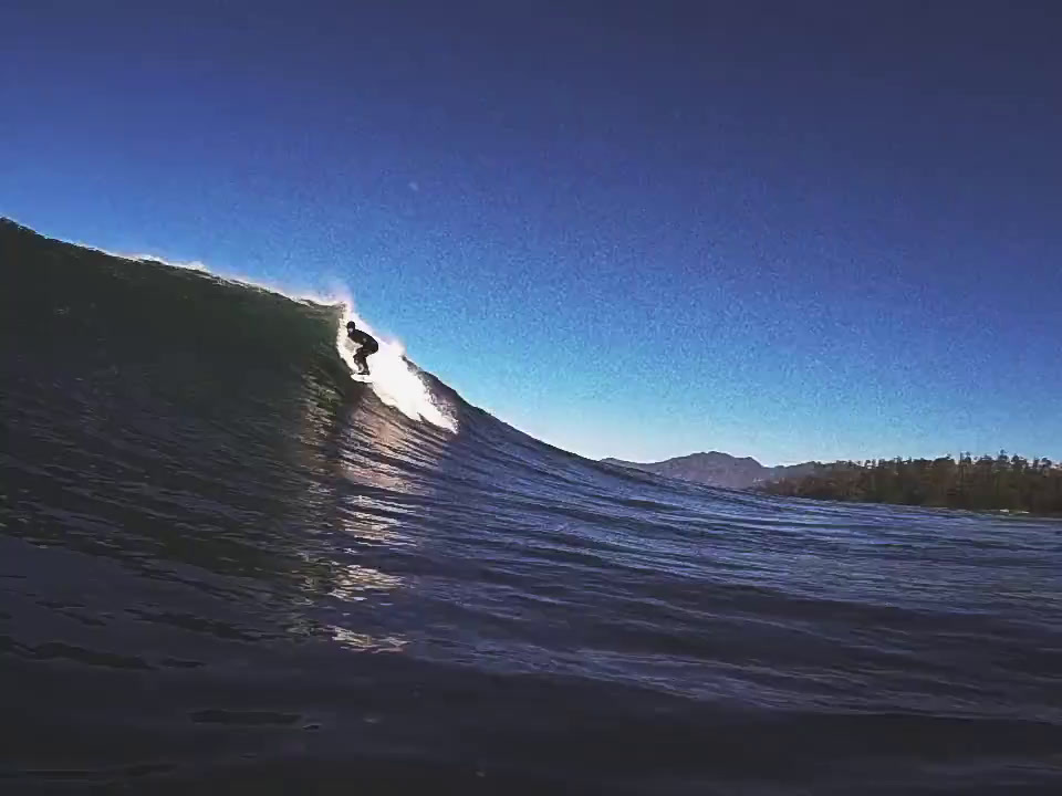 a man riding a wave on top of a surfboard