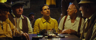 a group of men sitting around a wooden table