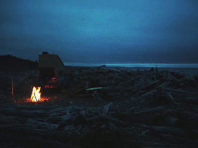 a truck is parked next to a campfire