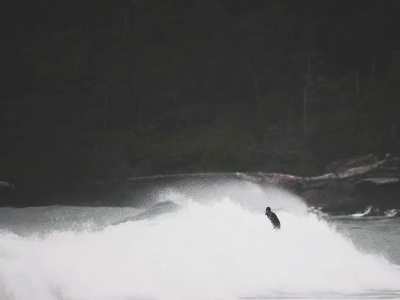 a man riding a wave on top of a surfboard