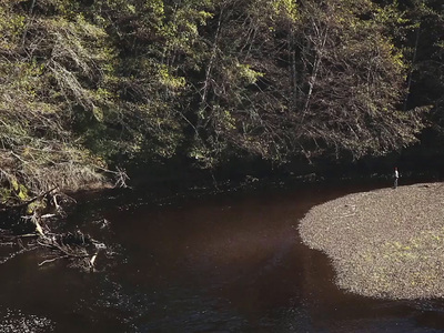 a man standing in the middle of a river