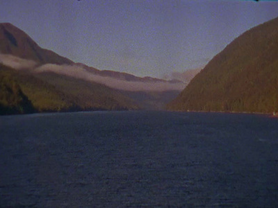 a body of water with mountains in the background