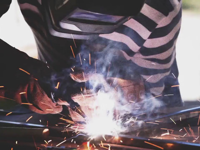 a person using a grinder on a piece of metal