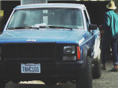 a man standing next to a blue truck