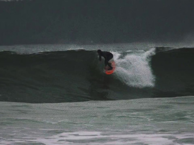 a man riding a wave on top of a surfboard