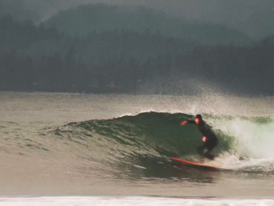 a man riding a wave on top of a surfboard