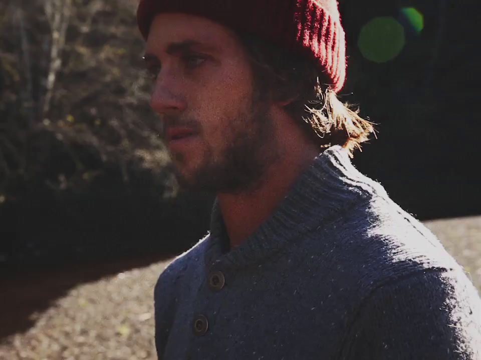 a man wearing a red hat and a gray sweater