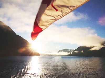 a flag flying over a body of water