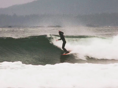 a man riding a wave on top of a surfboard