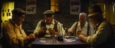 a group of men sitting around a wooden table