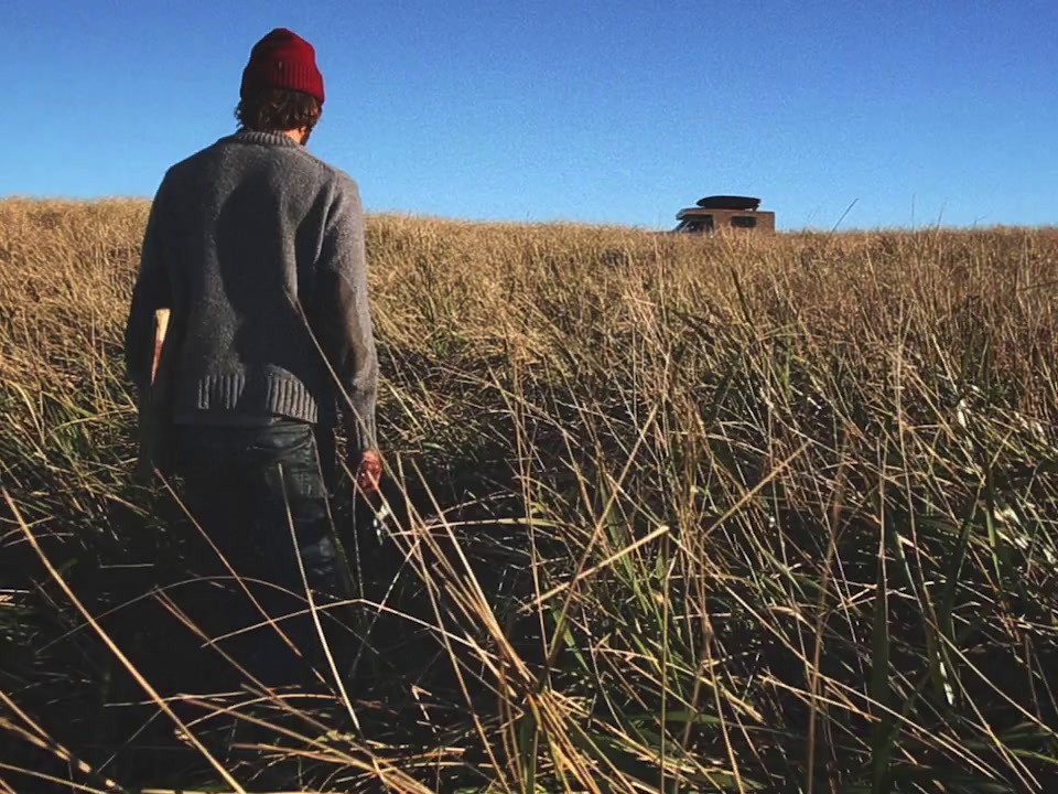 a man standing in a field of tall grass