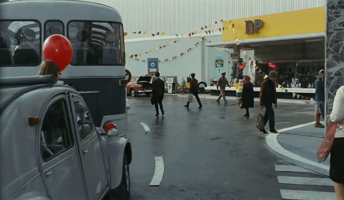 a group of people walking across a street