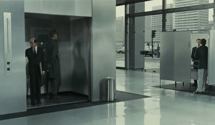 a man and a woman standing in an elevator