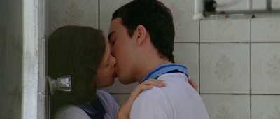 a man and a woman kissing in a bathroom