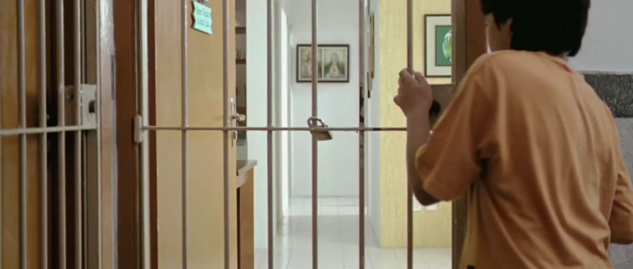 a man standing in front of a jail cell door