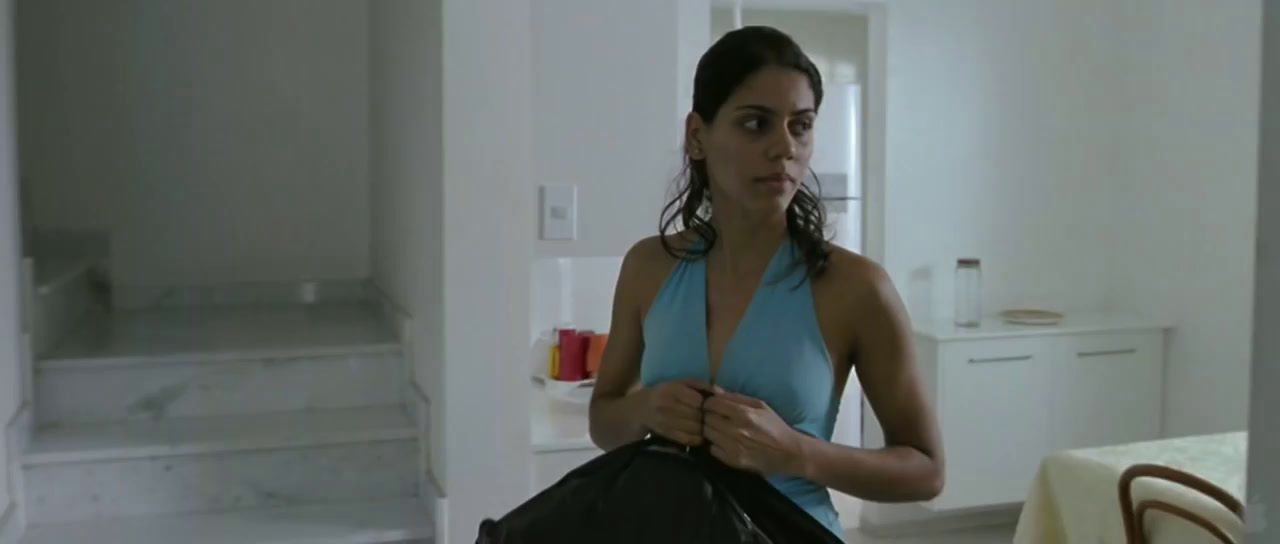 a woman in a blue tank top holding a black bag