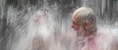 a man standing in a shower of water