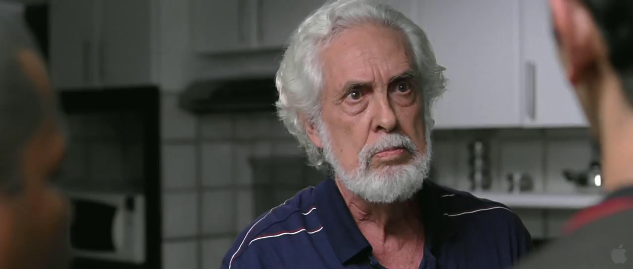 a man with a white beard and a blue shirt