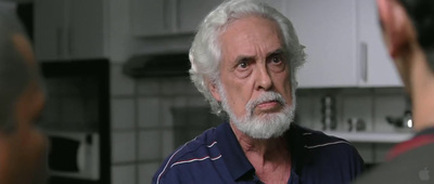 a man with a white beard and a blue shirt