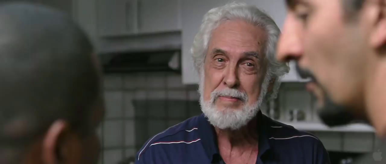 a man with a white beard is talking to another man