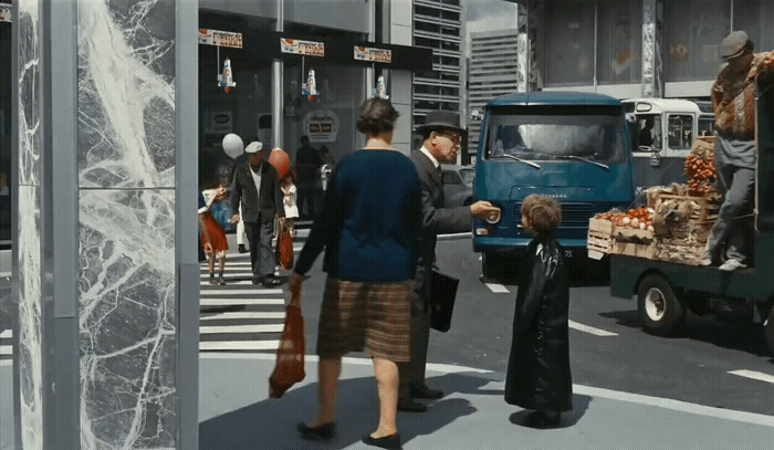 a group of people walking across a street