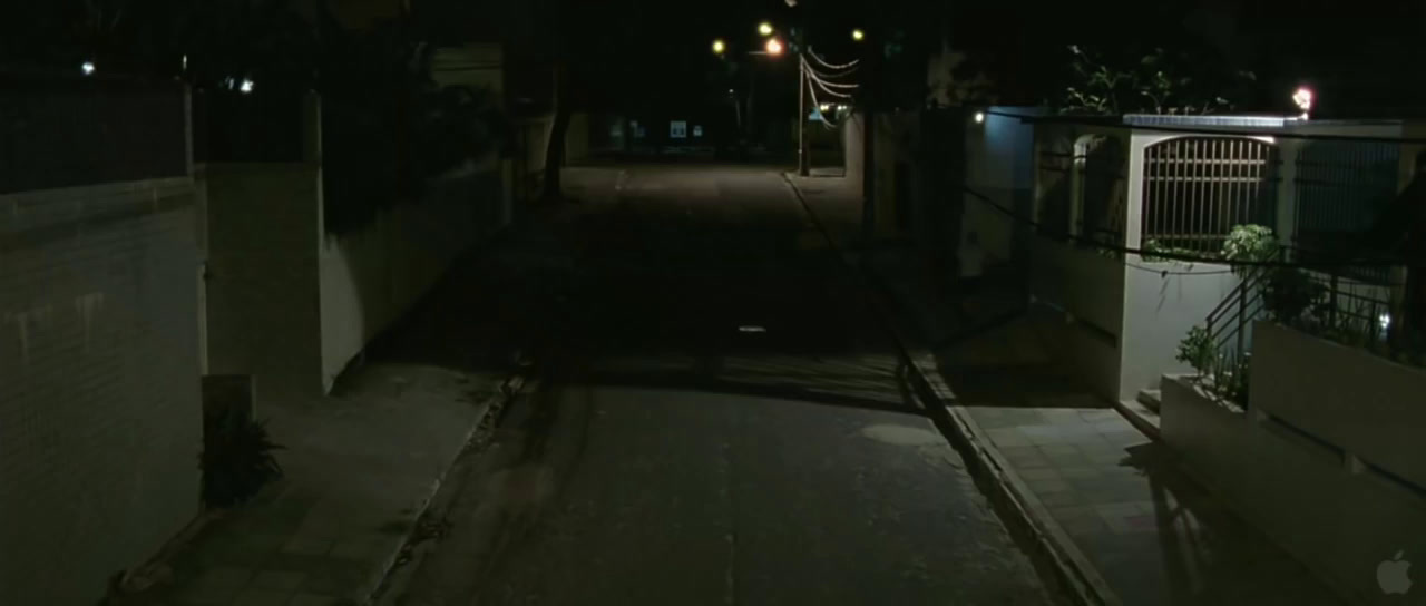 a dark alley at night with street lights on