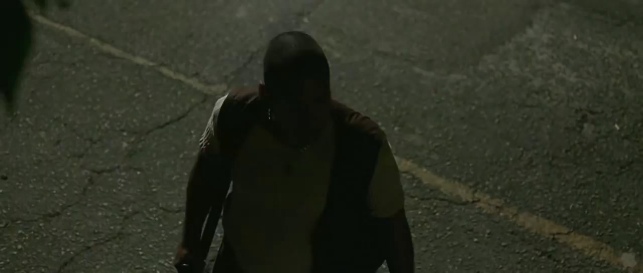 a man walking down a street at night