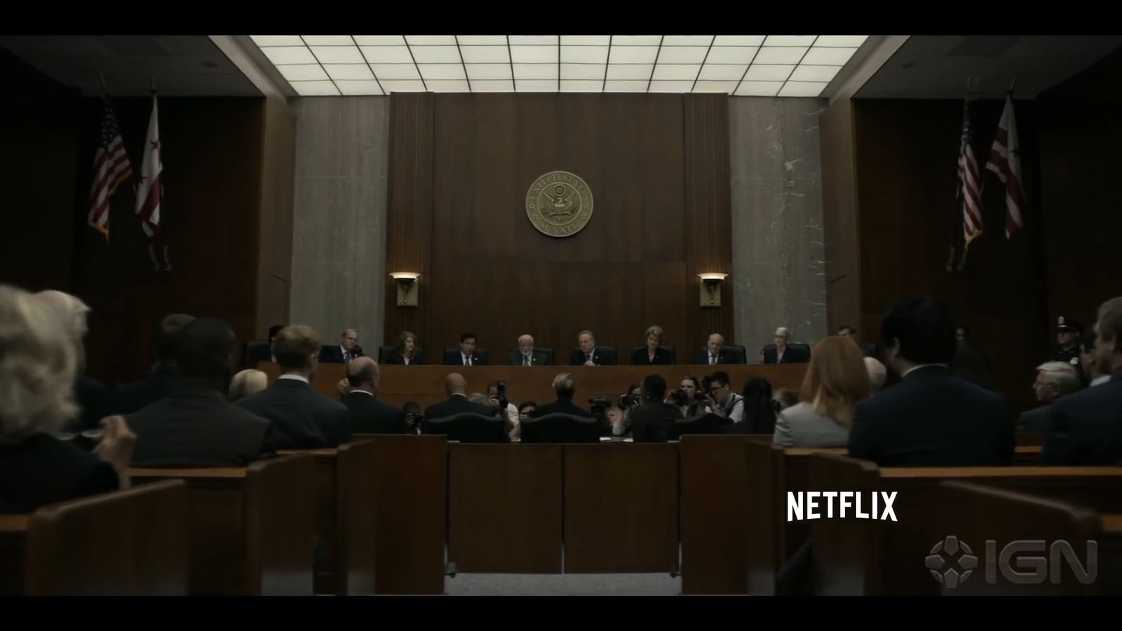 a group of people sitting in a courtroom