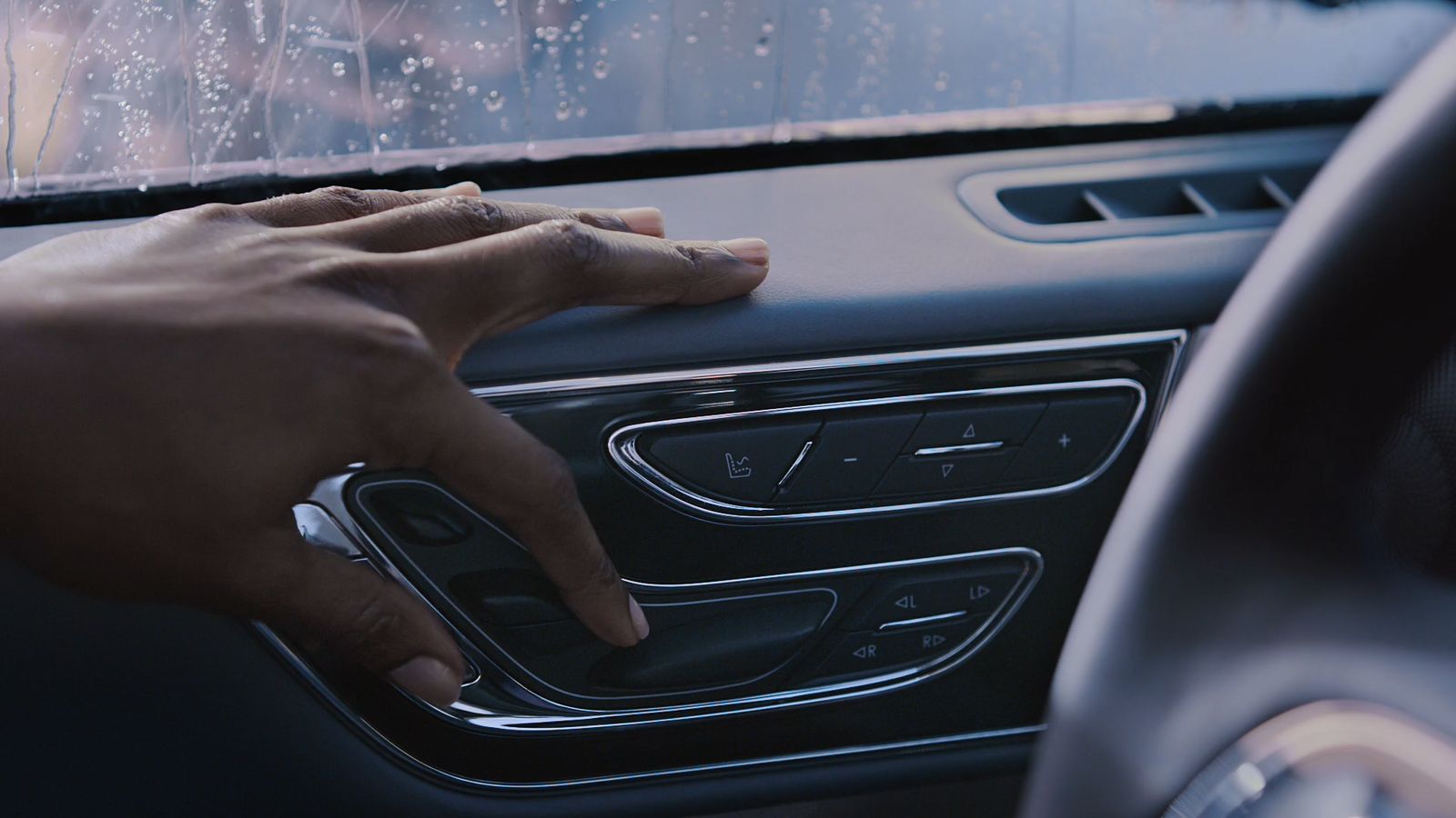 a person's hand on the dashboard of a car