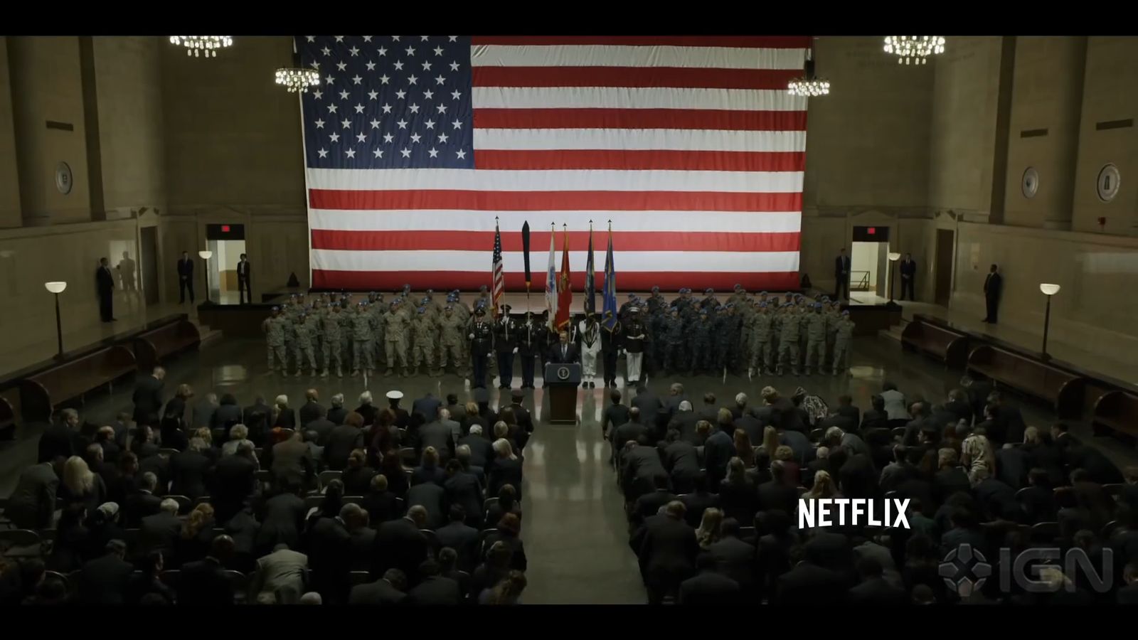 a group of people standing in front of an american flag