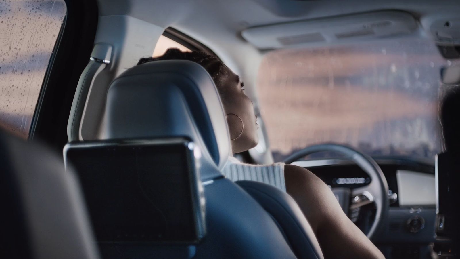 a woman sitting in the passenger seat of a car