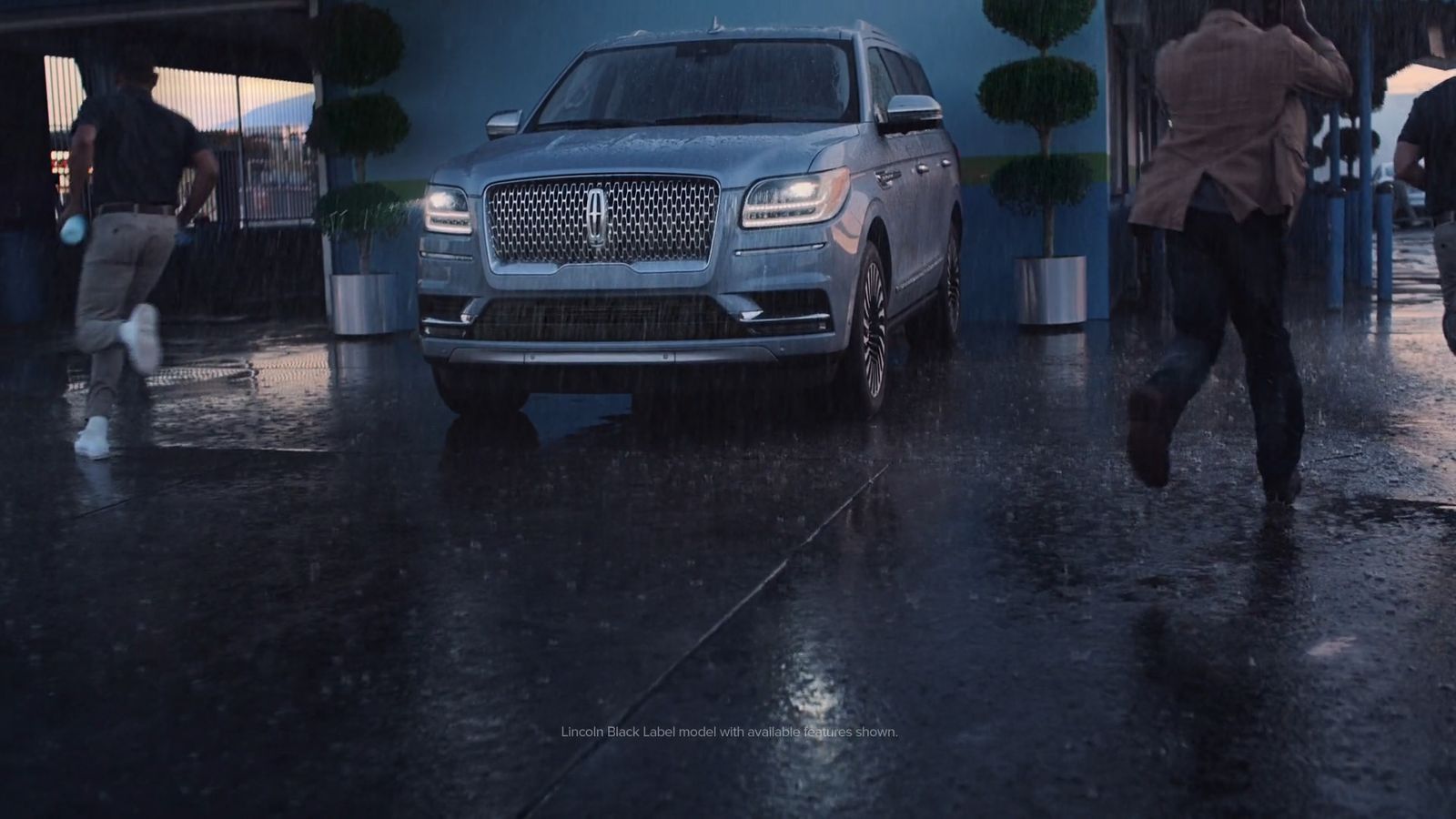 a car is parked in front of a building in the rain