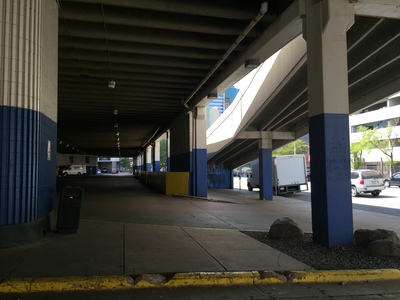 an empty parking garage with blue and white columns