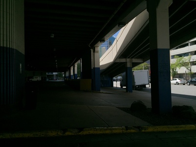 a view of a parking garage from under a bridge