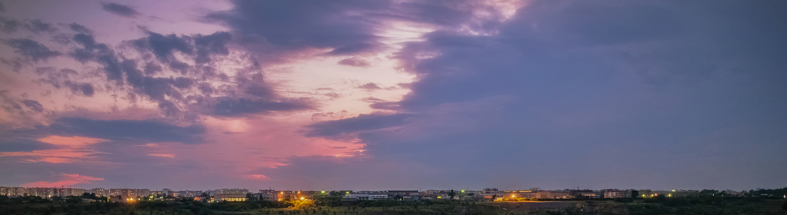 a view of a city from a distance at dusk