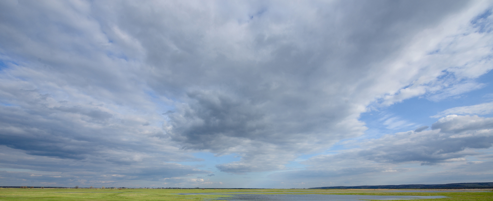 a large body of water under a cloudy sky