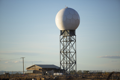 a large white water tower sitting next to a building