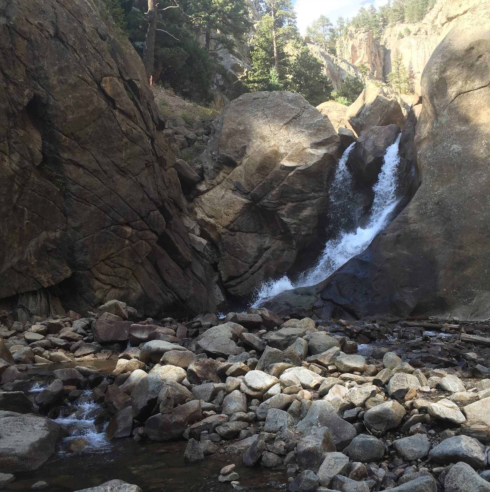 a stream of water running between two large rocks