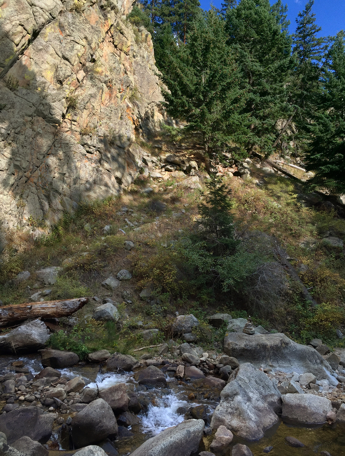 a mountain stream running between two large rocks