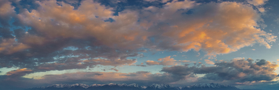 a view of a mountain range with clouds in the sky