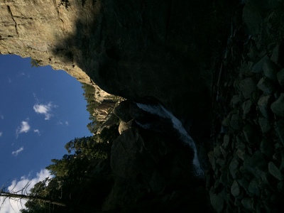 a view of the sky from inside a cave