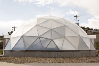 a large white dome sitting on top of a cement slab