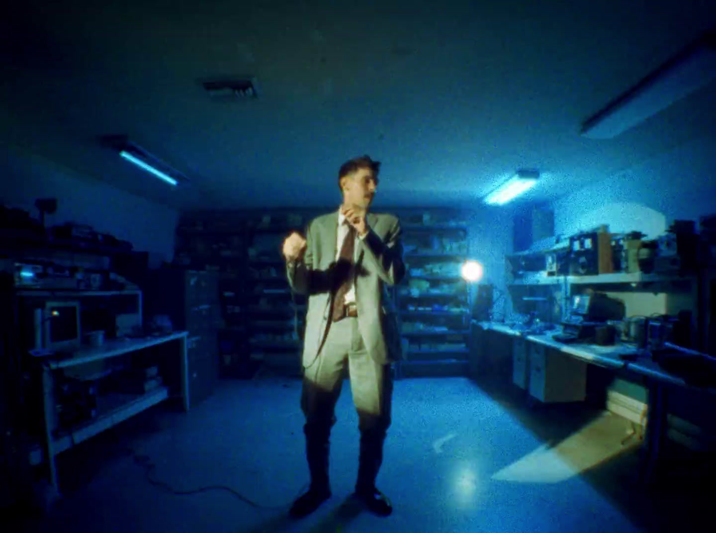 a man in a suit and tie standing in a room